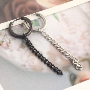 Detail of silver and black stainless steel hoop earrings with long hanging chain tassels