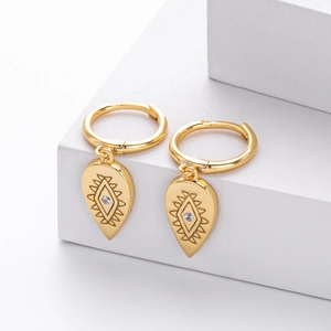 Detailed close-up of gold s925 silver teardrop earrings with engraved eye motif