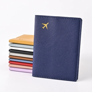 Detail view of premium PU leather passport covers in blue with gold airplane patterns