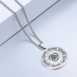 Close-up of silver Viking rune necklace with Celtic knot pendant and Nordic mythology design