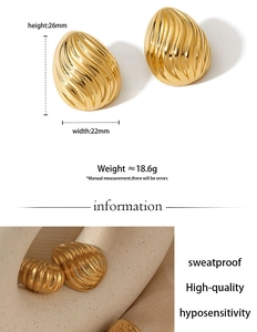 Macro detail of gold-plated striped geometric earrings featuring 18K luster and textures