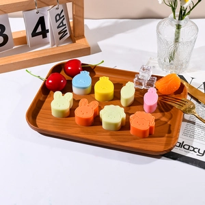 Close-up of colorful cartoon animal silicone molds on a wooden tray with a lifestyle setting