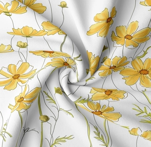 Detail of soft white fabric showing hand-painted yellow cosmos flower print texture