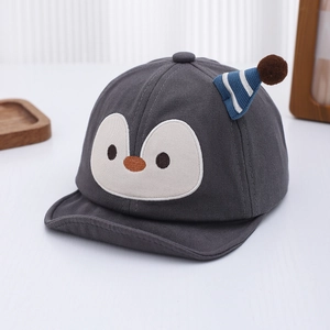 Close-up of baby penguin sun hat in dark grey cotton fabric with soft brim and plush ball