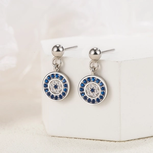 S925 sterling silver evil eye stud earrings with blue and white zircon stones on white stand