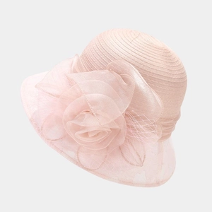 Detail of pink organza party hat with a large handmade floral accent and delicate beadwork