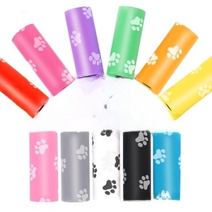 Colorful biodegradable pet waste bags with paw prints in eleven vibrant colors on white background