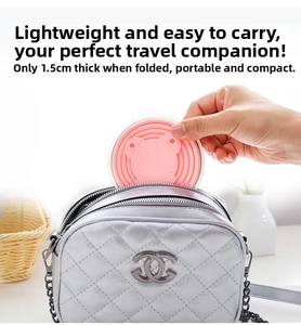 Pink portable silicone cup collapsed to 1.5cm thickness fitting in a small purse