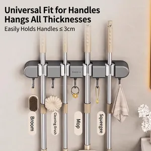 Wall-mounted mop holder with suction cups and hooks for bathroom tool organization