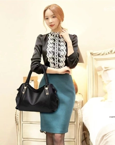 Asian model showcasing a high-quality large black soft leather handbag in a room.