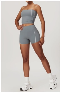 Detail of high-stretch sports bra and shorts set with white contrast stitching in blue