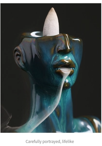 Detail of blue-green ceramic incense burner with a creative lifelike face sculpture design