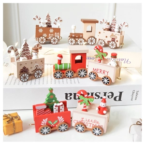 Detail of wooden Christmas train ornaments with snowman and tree on white background