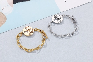 Detail of gold and silver tree of life pendants on heavy cable chains with OT clasp