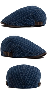 Detail of vintage navy striped flat cap with adjustable metal buckle and brown leather brim