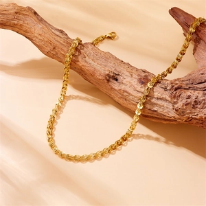 Minimalist gold link chain necklace displayed on vintage wood with a lobster clasp closure