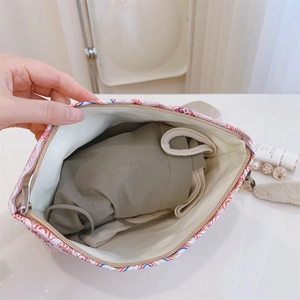 Detail view of large capacity makeup bag with geometric pattern and canvas lining