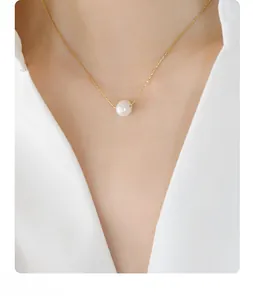 Detail shot of a natural freshwater pearl pendant on a thin 18K gold plated chain