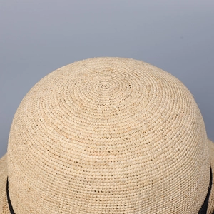 Artistic raffia straw hat with dome top and bow, featuring fine spiral handwoven texture