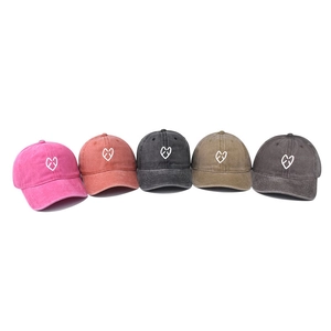 Washed cotton baseball caps in five colors featuring white heart embroidery on front