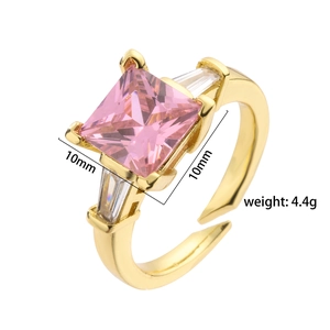 Macro view of gold adjustable ring with 10mm pink square zirconia and white side stones