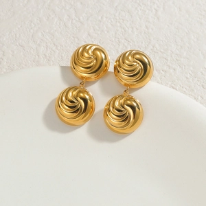 18K gold plated stainless steel round swirl stud earrings on white ceramic tray