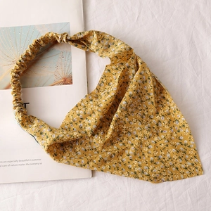 Detailed top view of bright yellow floral chiffon triangle headscarf with elastic band