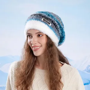 Women's winter warm knit hat with blue gradient pattern and white faux fur trim