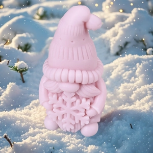 Pink Christmas gnome candle holding a large snowflake in a festive winter snow scene
