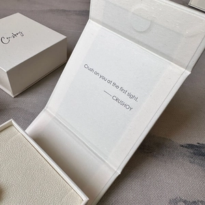 Elegant beige square magnetic jewelry box with fold-over book style cover and logo