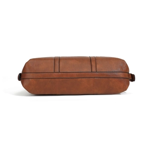 Detail of vintage brown leather tote bag with pebble texture and sturdy stitching