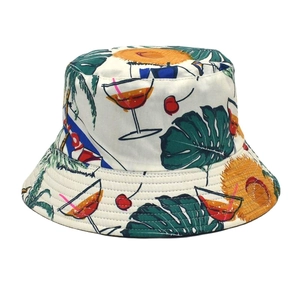 Close-up of double-sided bucket hat with colorful tropical fruit and cocktail patterns