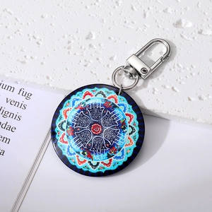 Macro view of blue evil eye mandala pendant keychain with metallic lobster clasp