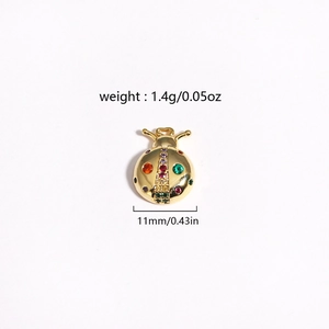 Detailed view of 11mm ladybug pendant in gold finish with weight and size specifications