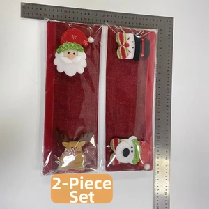 Detail of Christmas fridge handle covers with plush Santa and Reindeer decorations