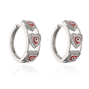 Macro shot of silver heart earrings with red evil eye enamel and clear zircon stones