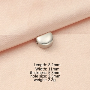 Detailed view of silver stainless steel spacer bead with size dimensions on pink silk