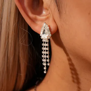 Macro view of teardrop drop earrings with sparkling diamond tassel fringe detail