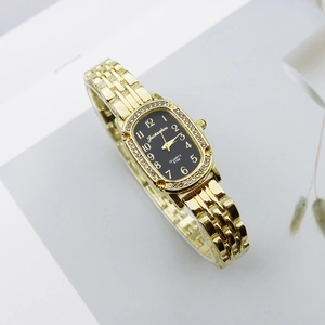 Detail shot of the rhinestone-set bezel and gold-tone alloy band of this women's watch