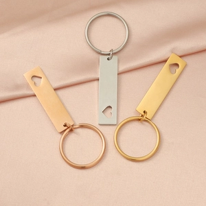 Set of 3 hollow heart tag keychains in gold silver and rose gold on pink silk