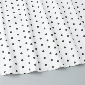 Macro detail of polka dot print fabric showing high quality stitching and texture