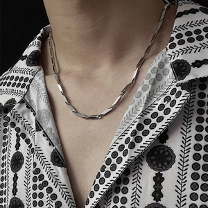 Polished silver titanium steel chain with bamboo-shaped geometric links on a model