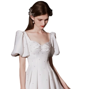 Elegant white satin wedding dress with pearls, sweetheart neck, and puff sleeves