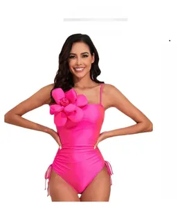 Detail of rose red one-piece swimsuit with 3D floral accent and adjustable side drawstrings