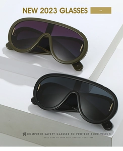Detail view of olive green and black oversized shield sunglasses on display stands