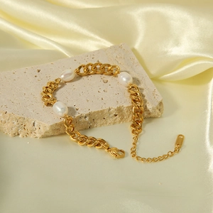 18K gold-plated stainless steel link bracelet with natural pearls on a textured stone