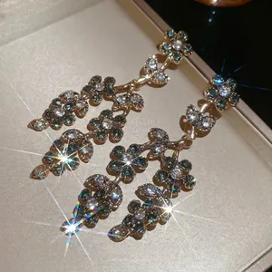 Vintage floral tassel earrings in gold with green crystals and sparkling rhinestones