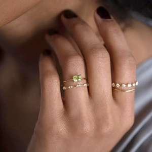 Macro shot of gold S925 rings set with marquise gemstone on a model hand