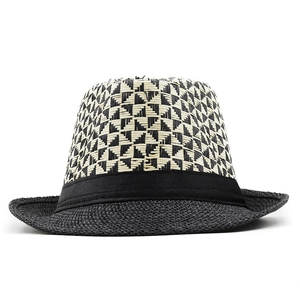 Detail of black and white geometric diamond weave pattern on a breathable summer straw hat