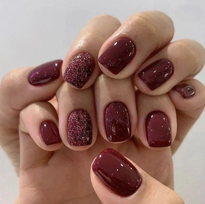 Short square dark wine red press-on nails with glossy solid finish and glitter accents